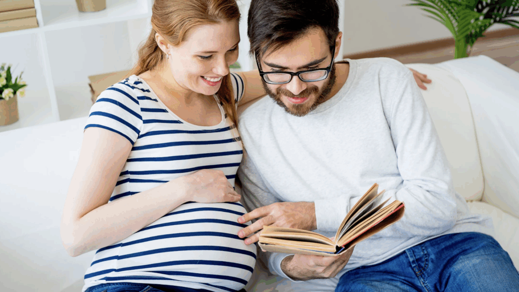 Young couple sitting together, reading a book, with the woman visibly pregnant.
How to Gain Financial Security